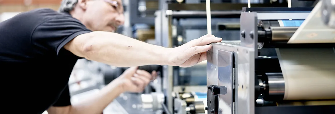 man checking printing machine