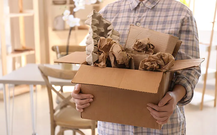 man throwing out wastepaper in paper box