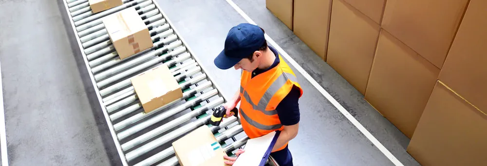 Person in Versandhaus am Rollband Person in Versandhaus am Rollband