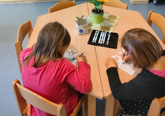 Kinder malen Osterkörbchen an 