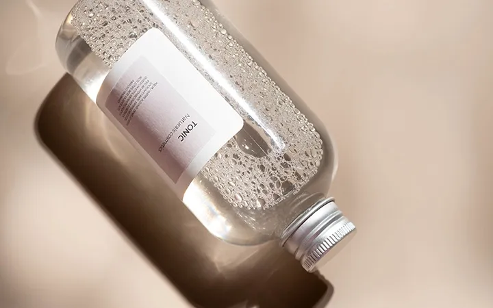 Filled glass bottle with sandwich label