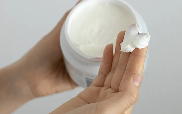 Cream jar in the hand